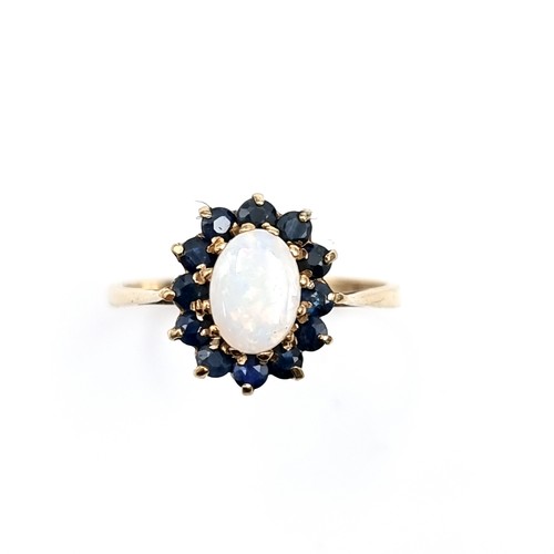 593 - Star Lot : A very pretty nine carat gold fire opal ring with sapphire cluster surround. Ring size - ... 