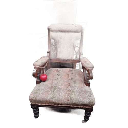 434 - Victorian upholstered armchair features an intricately carved mahogany frame and floral tapestry fab... 