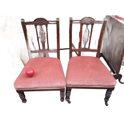 436 - Pair of Victorian mahogany side chairs with carved backs and upholstered seats. The chairs feature t... 