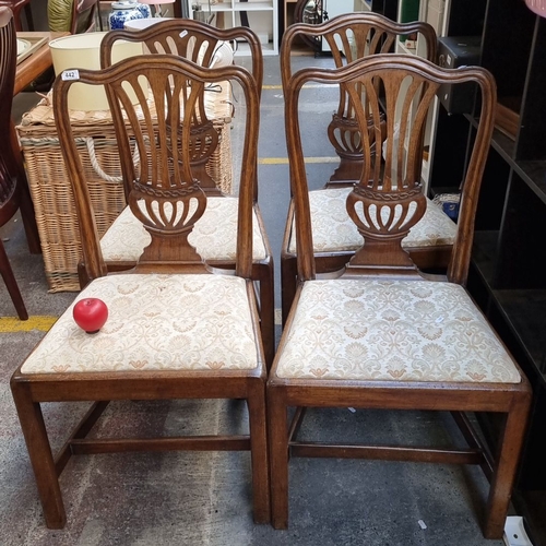 442 - Set of four oak dining chairs with carved backs and upholstered seats, featuring intricate patterns ... 