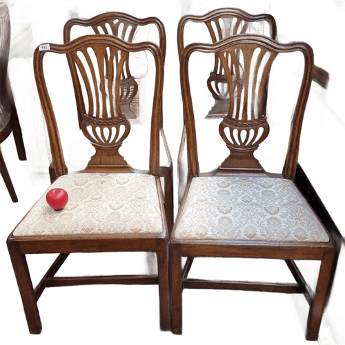 442 - Set of four oak dining chairs with carved backs and upholstered seats, featuring intricate patterns ... 