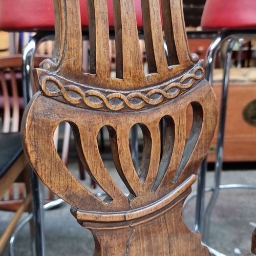 442 - Set of four oak dining chairs with carved backs and upholstered seats, featuring intricate patterns ... 