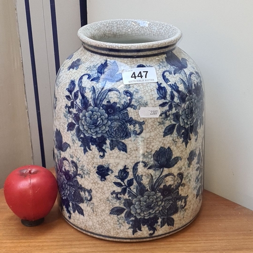 447 - Blue and white Chinese porcelain vase with floral motifs and a crackled glaze finish. Similar to the... 