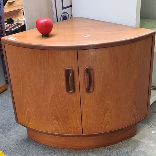 448 - A G Plan Mid-Century Modern corner cabinet in teak, featuring two curved wooden handles and spacious... 