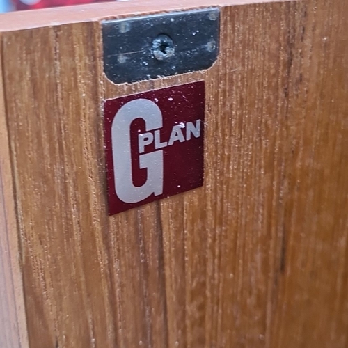 448 - A G Plan Mid-Century Modern corner cabinet in teak, featuring two curved wooden handles and spacious... 