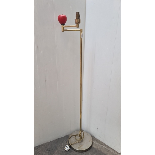 449 - An Adjustable Modern brass floor lamp with an adjustable arm and red apple accent, features a circul... 