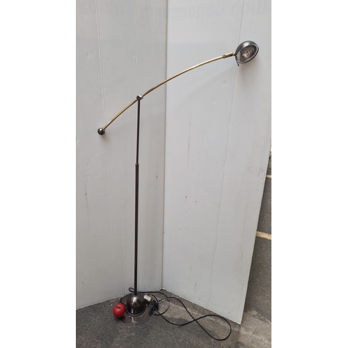 450 - An adjustable floor / reading lamp with adjustable brass and chrome arm and base. Features adjustabl... 