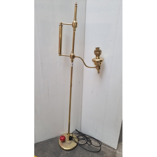 451 - Brass floor lamp, in the Edwardian style with an adjustable arm and electric fitting. It features cl... 