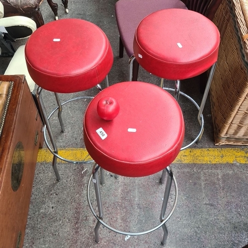 458 - Set of three red retro bar stools with chrome legs. Retro design. These are very cool.