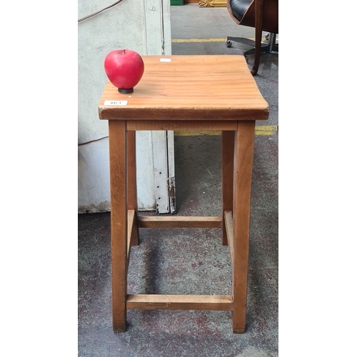 463 - Small wooden stool crafted from golden oak, featuring a simple, sturdy design with four square legs ... 