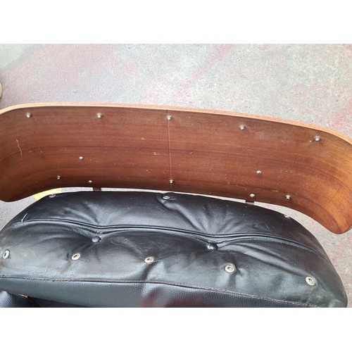 468 - Star Lot : A fabulous Mid-Century Modern Eames-style lounge chair. Black leather upholstery with ros... 