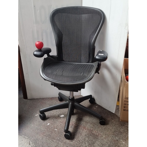 479 - Star Lot : A super Herman Miller Aeron B office chair in black mesh features adjustable armrests and... 