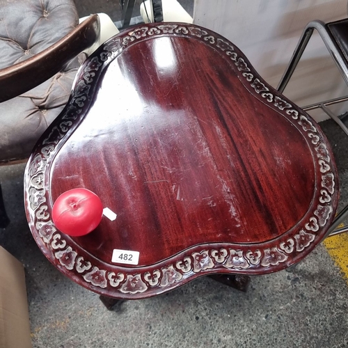 482 - Victorian-style mahogany teapoy with intricately carved detailing, featuring a trifid base and pedes... 