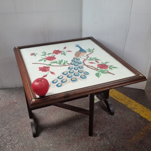 486 - A vintage fire screen with wooden pop up table features a framed embroidered peacock and floral desi... 