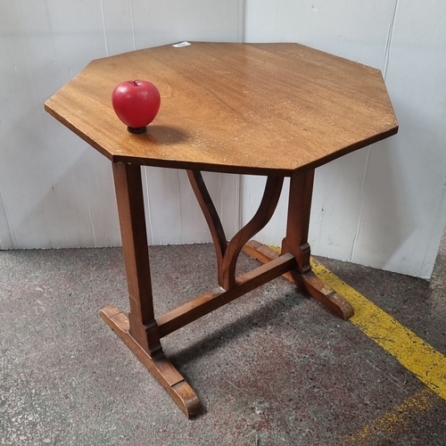 488 - Octagonal wooden pop up side table with pedestal base and curved supports, from the mid-20th century... 