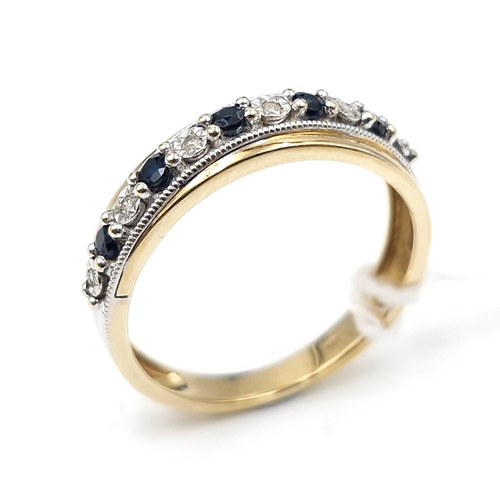 10 - Star lot : A diamond and sapphire half eternity ring set in nine carat gold. Size - M 1/2. Weight - ... 