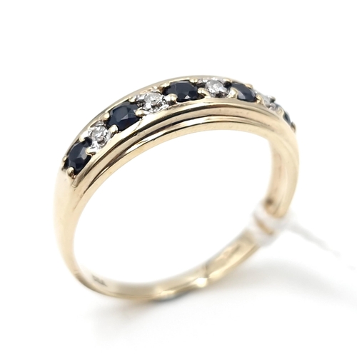 11 - Star Lot : A nine carat gold diamond and sapphire ring. Size - Q. Weight - 2.3 grams.