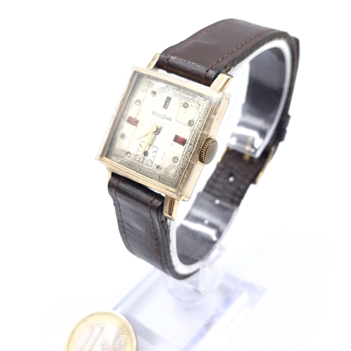 16 - A vintage Bulova wristwatch set with square dial with wind up mechanism and leather strap. Watch in ... 