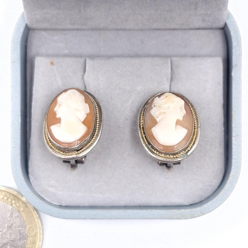 19 - A pair of vintage continental silver (800) clip on cameo earrings. Weight - 4.87 grams. Boxed.