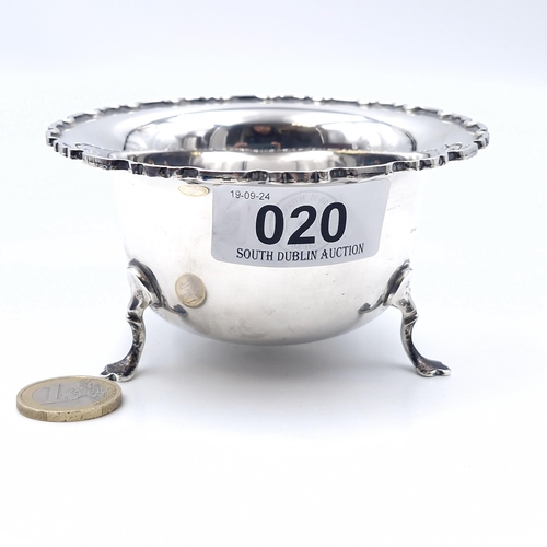 20 - A sterling silver hallmarked Birmingham dish with pie crust rim standing on three paw feet dated 195... 