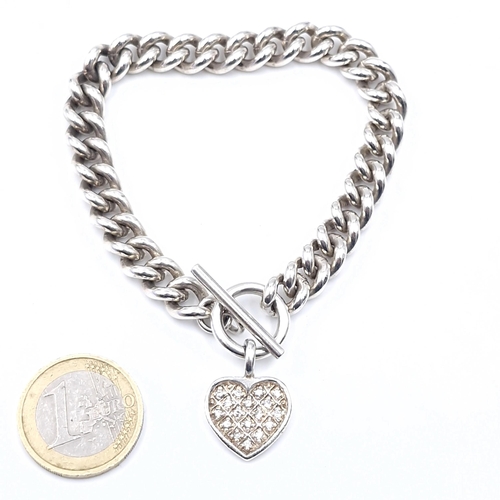 25 - A sterling silver heavy gauge bracelet set with heart charm and T-bar clasp. Weight - 48.82 grams.