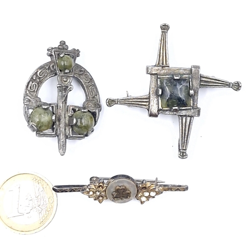 29 - A collection of three antique brooches - two with celtic design set with Connemara stone accents. To... 