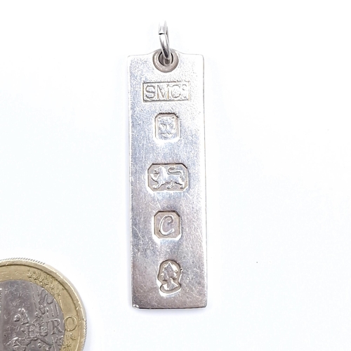 37 - A sterling silver ingot hallmarked London. Length - 4 cms. Weight - 15.2 grams. Boxed.