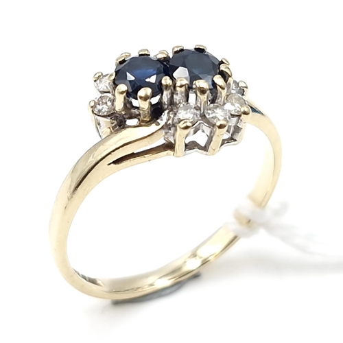 4 - Star lot : A nine carat gold two stone sapphire and diamond ring. Ring size - I 1/2. Weight - 1.7 gr... 