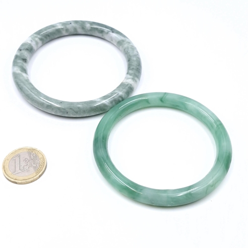 44 - Two Jade bangles - stones cold to touch. Total weight of items - 74 grams.