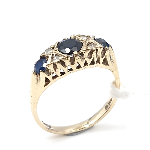 5 - Star Lot : An attractive vintage nine carat gold three stone sapphire & diamond set ring. Size - M 1... 