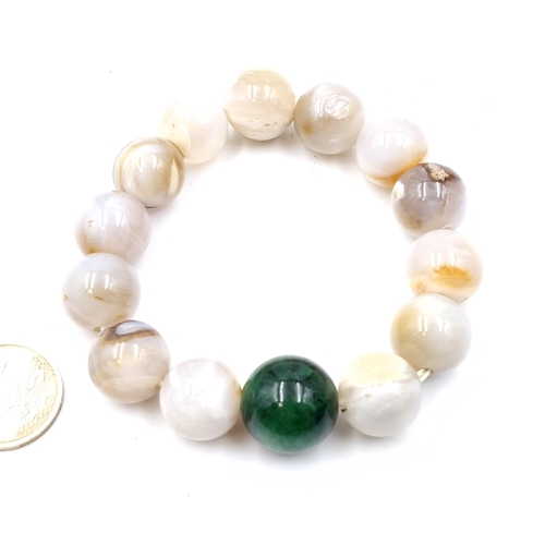 51 - An attractive agate polished stone expandable bracelet - stones cold to touch. Weight - 90.63 grams.