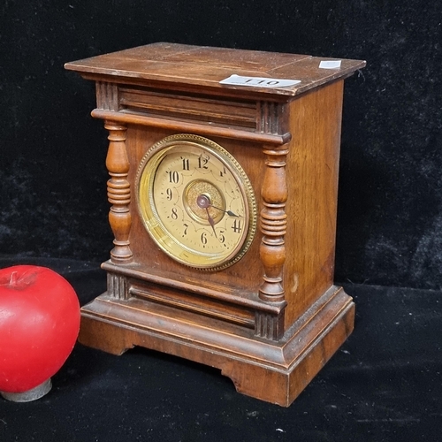 110 - A vintage Junghans wooden mantel clock with brass accents.