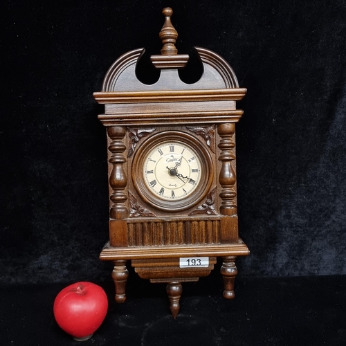 193 - A Camelot quartz wall clock boasting beautiful turned columns, finials and floral motifs in high rel... 