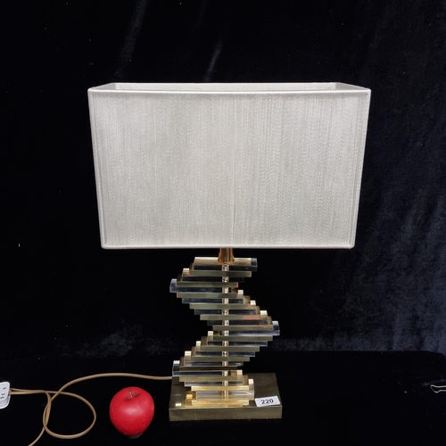 220 - A lovely table lamp with brass toned and glass geometric stripe base with beige shade.