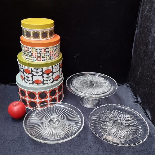 271 - A set of 4 Orla Kiely designer graduating cake tins along with 3 glass cake stands.