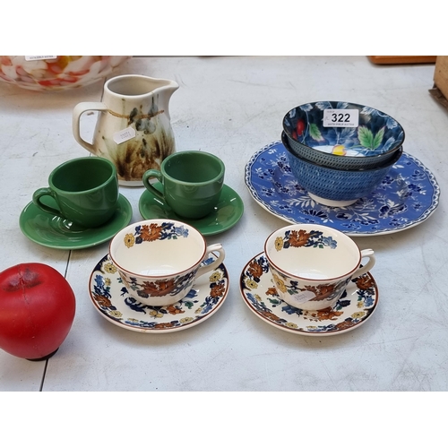 322 - A collection of vintage ceramics including teacups, Chinese bowls, and a hand painted jug.