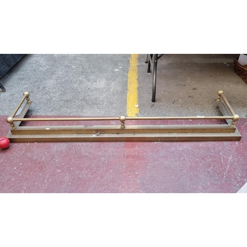 325 - A large Victorian brass fire fender surround. MM: 152cm