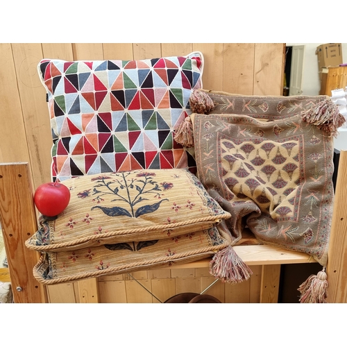 330 - Four tapestry cushions and a CDE geometric cushion.