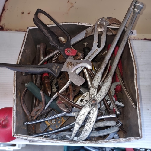 339 - A tin metal box containing pliers, strippers and adjustable wrenches.