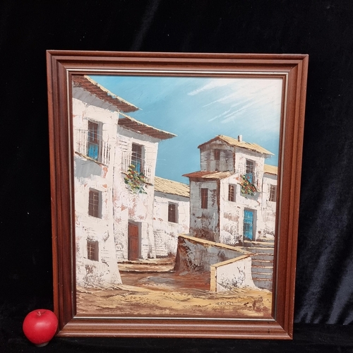 87 - A bright original oil on canvas painting. Features a Spanish Village. Rendered in blues, browns and ... 