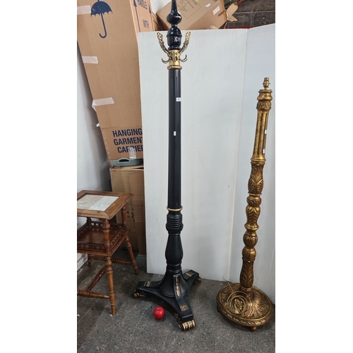 877 - Star lot : A fabulous large coat stand, featuring a black lacquered wooden column with brass hooks a... 