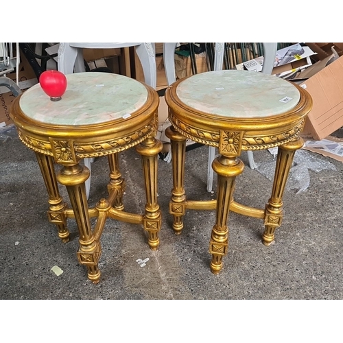 884 - Star lot : A lovely Pair of gilt wood side tables with round cold Italian  marble tops, featuring or... 