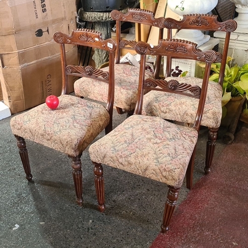 886 - Four Victorian dining chairs with carved mahogany frames and floral upholstered seats.