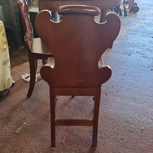 887 - A Pair of Victorian mahogany hall chairs with intricately carved gothic accents and turned front leg... 