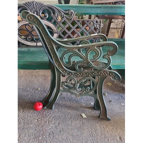 890 - Ornate cast iron bench ends with intricate scrollwork design. Vintage aesthetic with green finish.