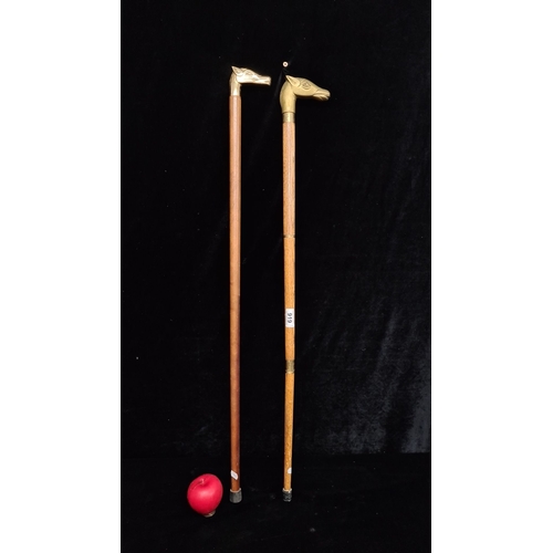 919 - Pair of wooden walking sticks with brass horse head handles.