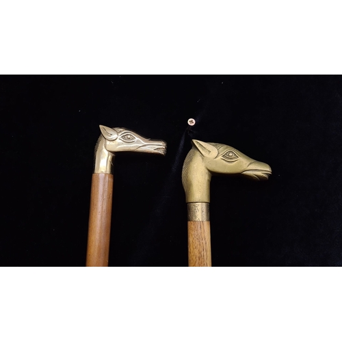 919 - Pair of wooden walking sticks with brass horse head handles.