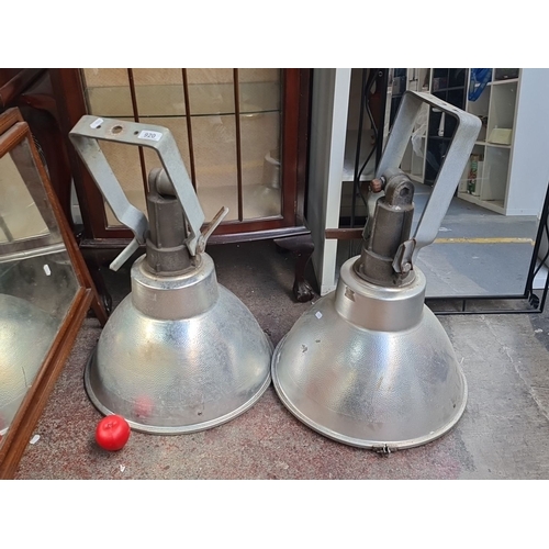 920 - Pair of large industrial metal spotlights with adjustable brackets.