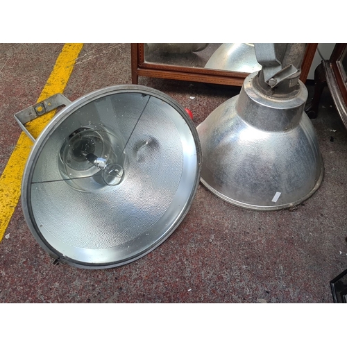 920 - Pair of large industrial metal spotlights with adjustable brackets.