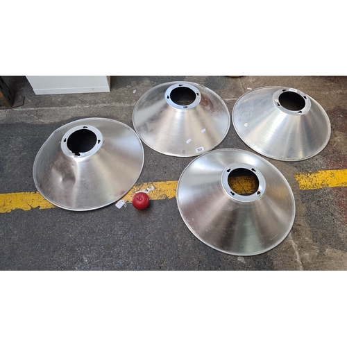 922 - Set of four large aluminum industrial light reflectors.